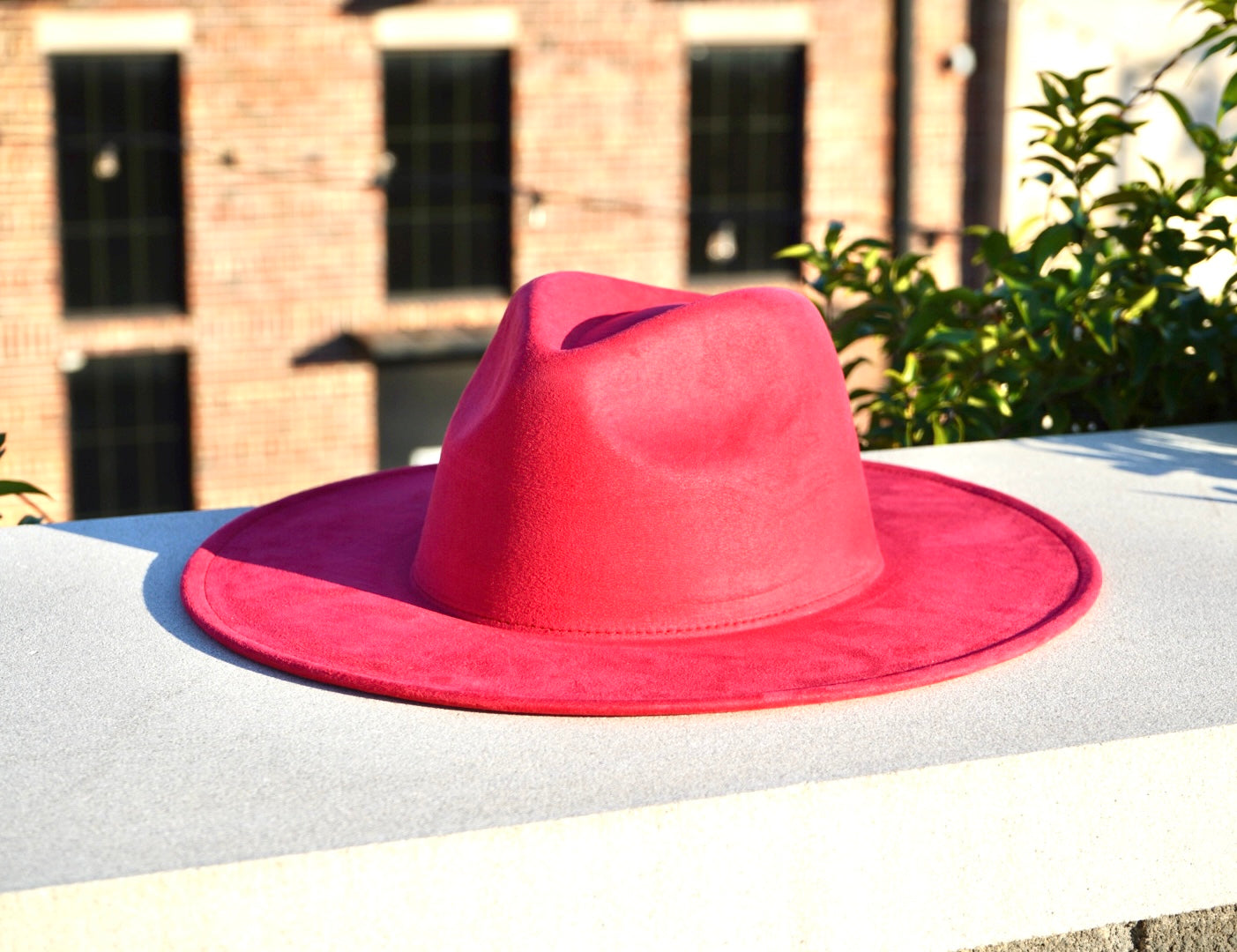 Women's faux suede fedora hat in a watermelon pink color.